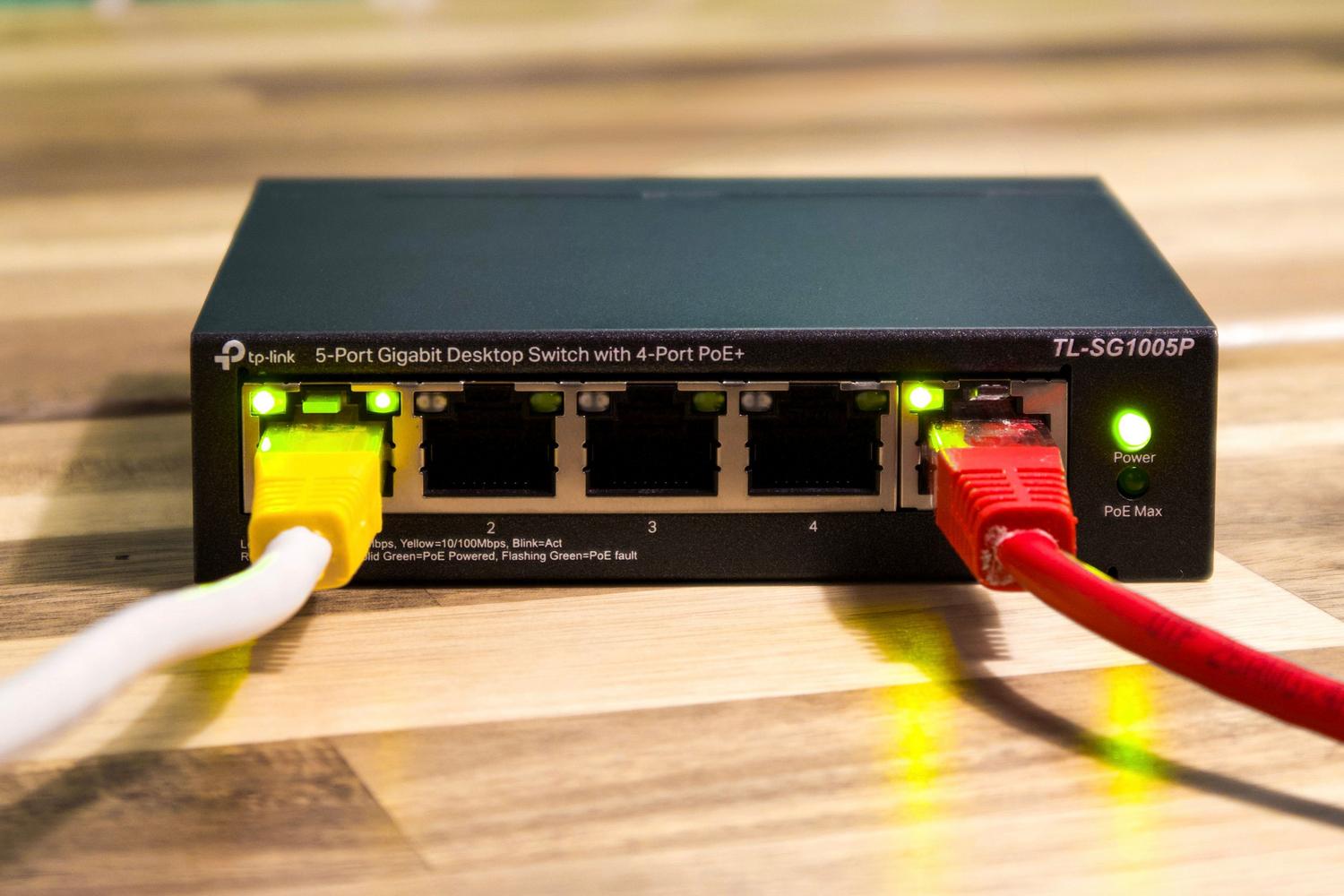 Close-up of Ethernet cables connected to a network switch, illustrating the stability of wired connections.