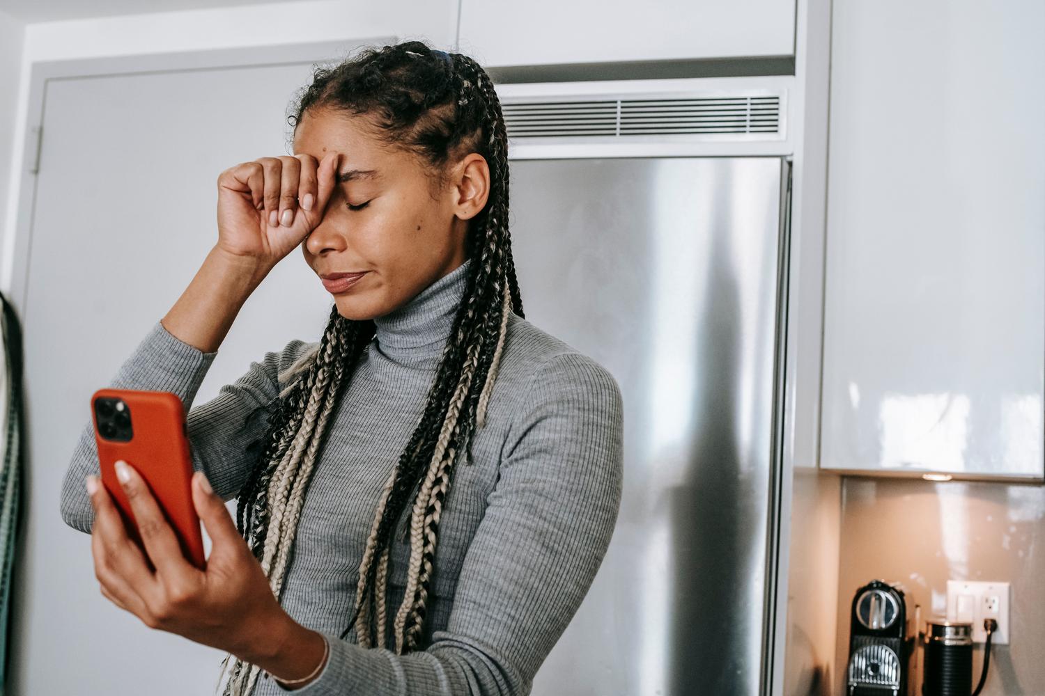 Frustrated woman during a video call, representing the common problem of bad WiFi connection and dead zones.