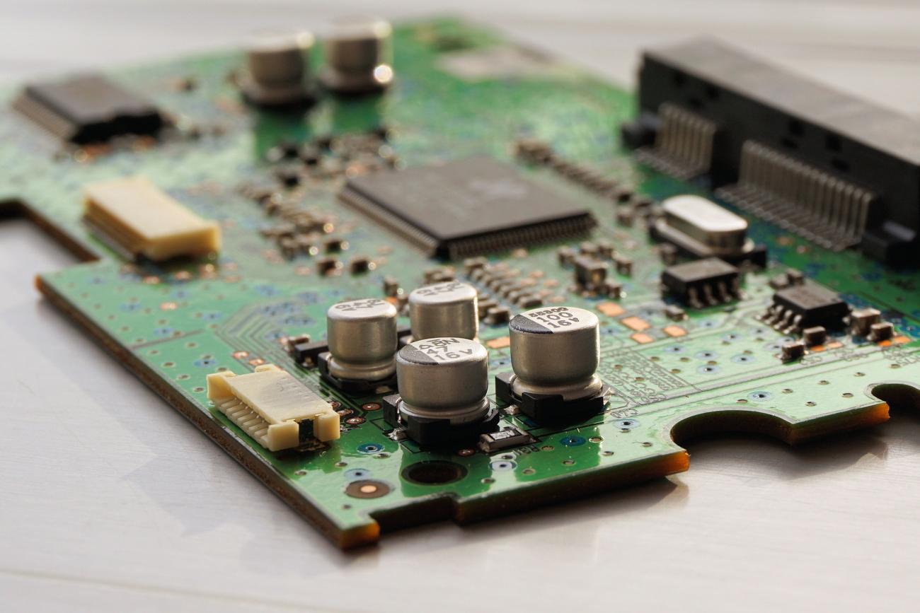 Detalle de una placa de circuito impreso con microchips, representando la base técnica invisible y la portabilidad de NetBSD.