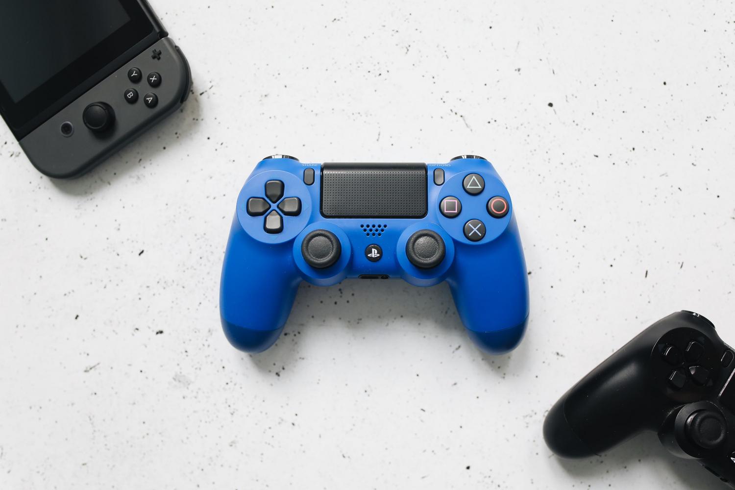 Colección de mandos de Nintendo Switch, PlayStation y Xbox sobre fondo blanco, mostrando la diversidad de controladores actuales.
