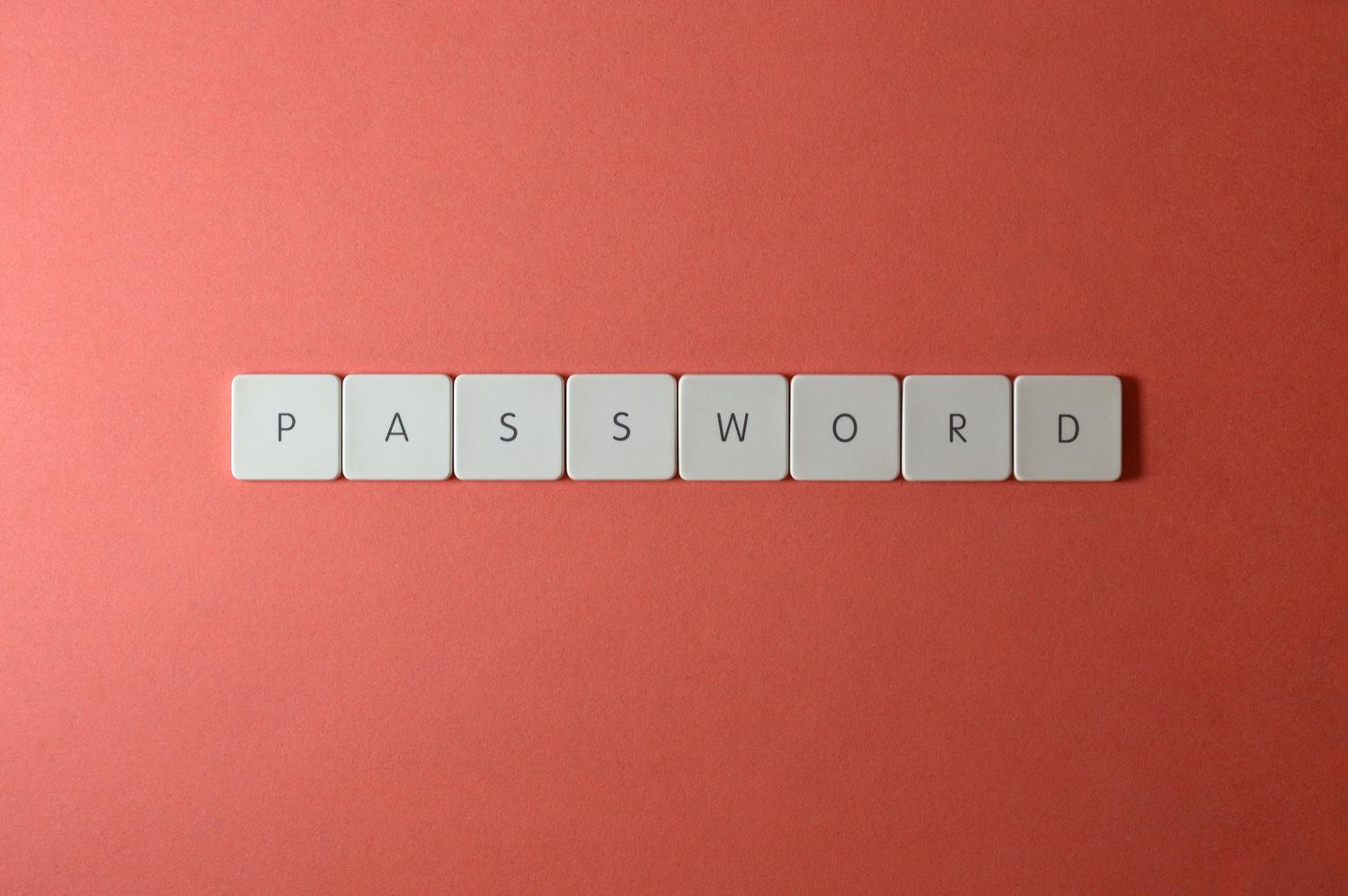 Letras formando la palabra PASSWORD sobre un fondo coral, simbolizando la seguridad de las contraseñas y la protección de cuentas.