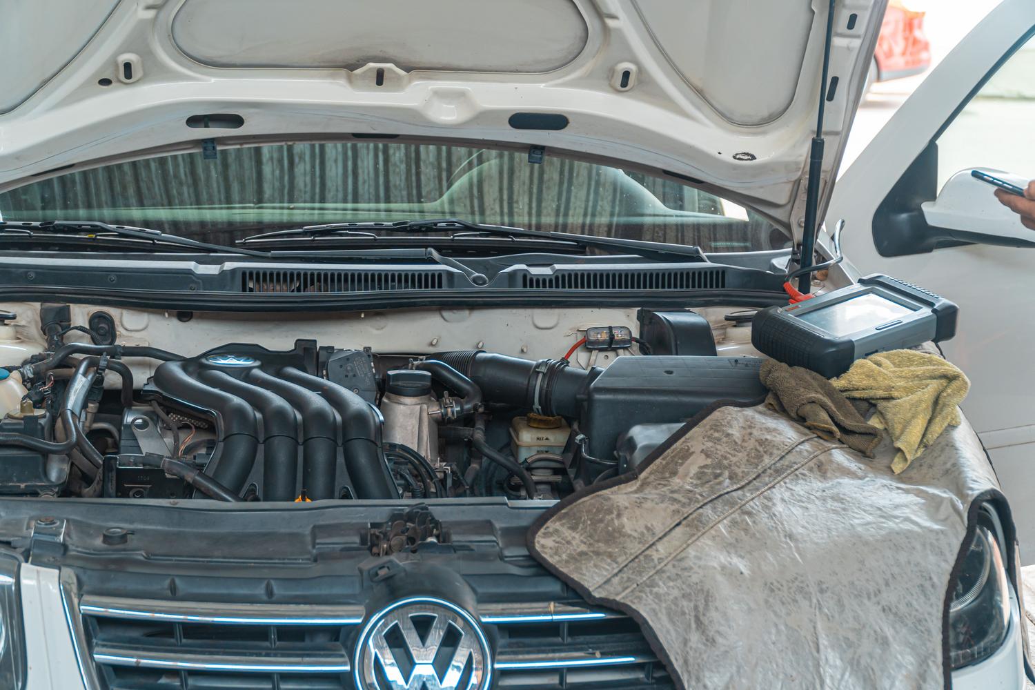 Close-up of a car engine bay undergoing maintenance to resolve VVT synchronization issues