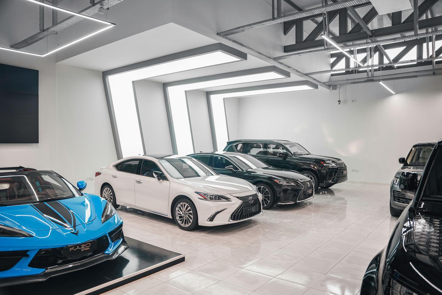 Vista de un showroom moderno con coches de lujo alineados, representando la experiencia física del punto de venta.