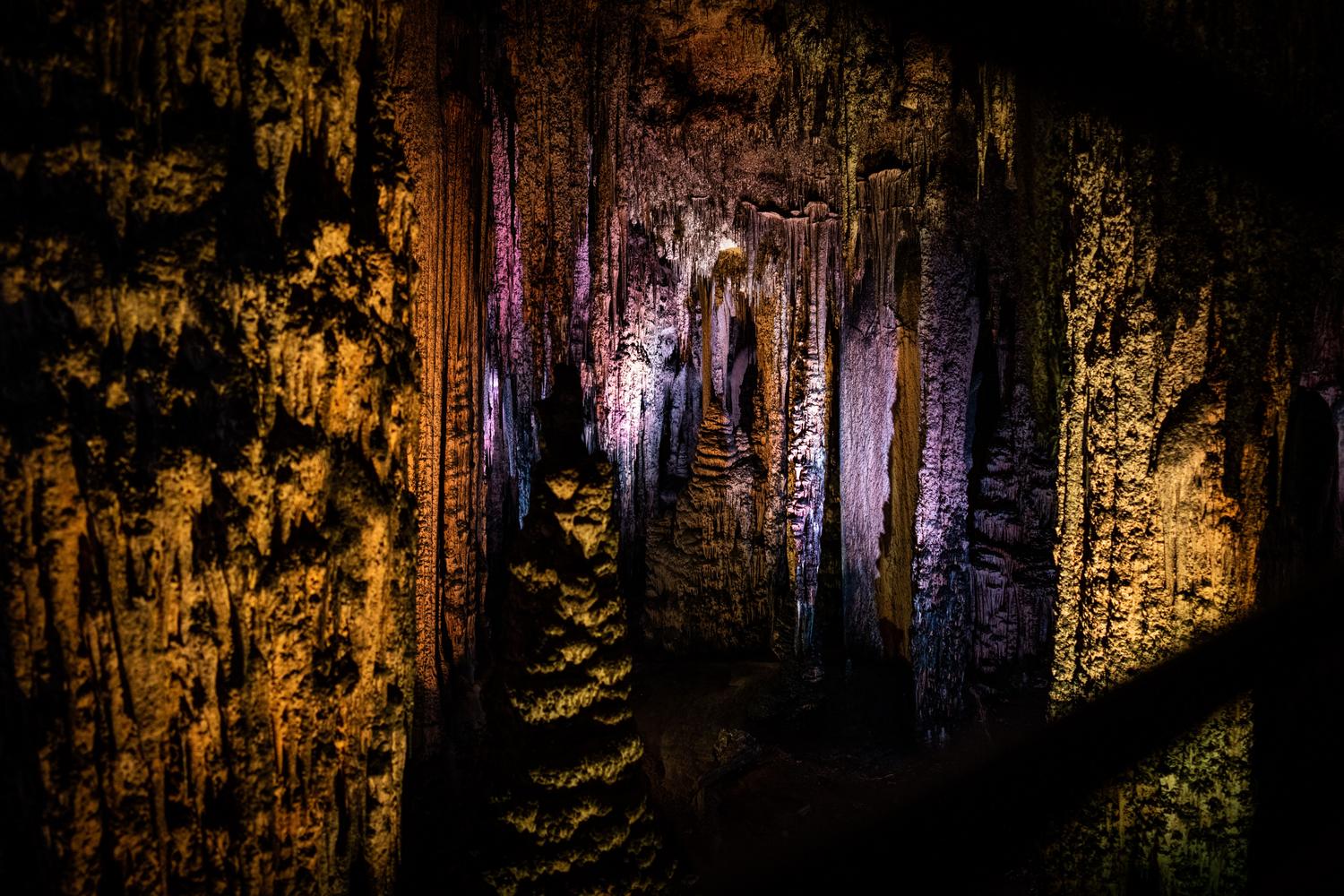 Mysterious illuminated cave with stalactites representing the Spirit Cave in The Forge