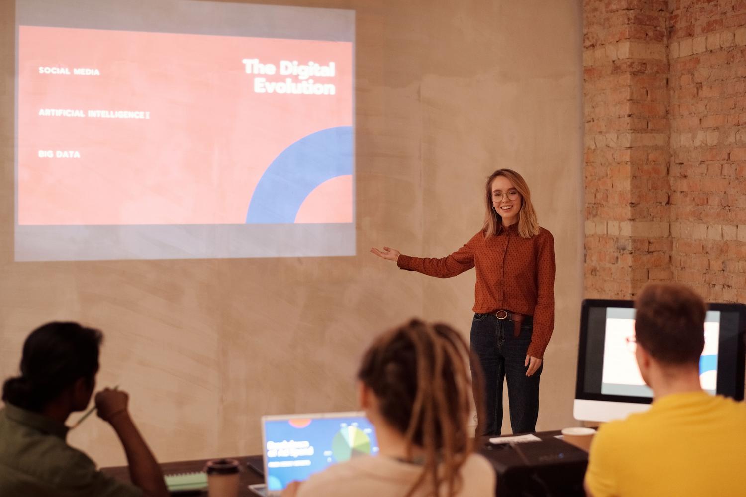 Presentadora exponiendo sobre inteligencia artificial y big data en un entorno empresarial moderno.