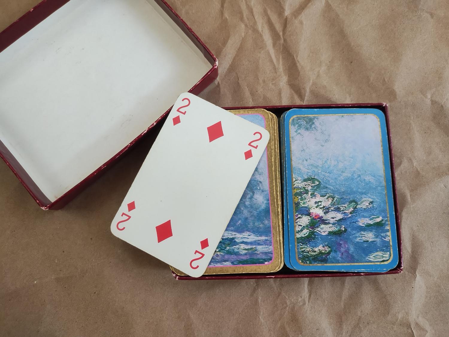 Naipes antiguos sobre un fondo rústico, representando la esencia del juego de cartas Gwynt.